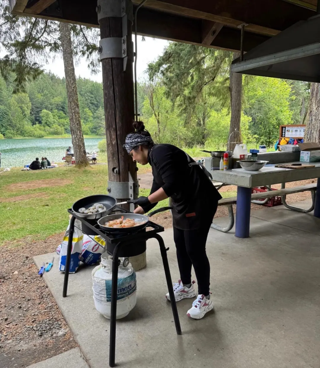 Cooking over a propane burner outdoors by a lake